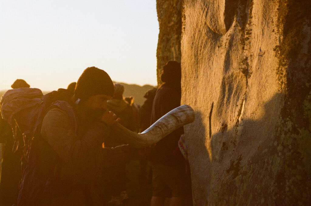 people touching rock face