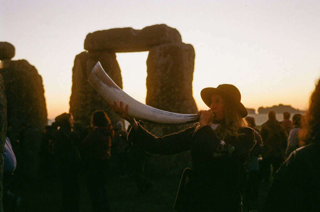 stonehenge horn player at sunset