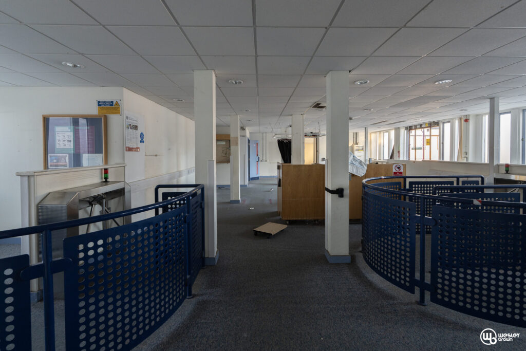 Broadmoore Hospital_44 copy Interior of Broadmoor Hospital showing an empty corridor with barriers.