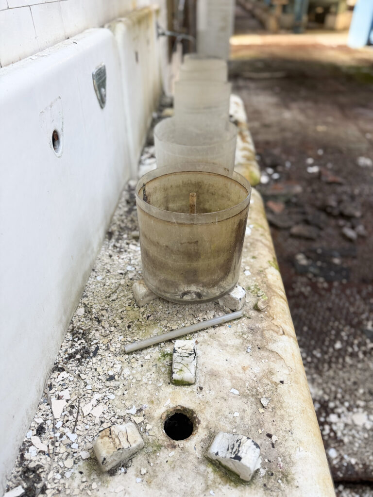 Iphone_17_Pro-derps-UE-reserviour-wales-derelict-abandonned-urbex-exploration abandoned basin with stained plastic cup